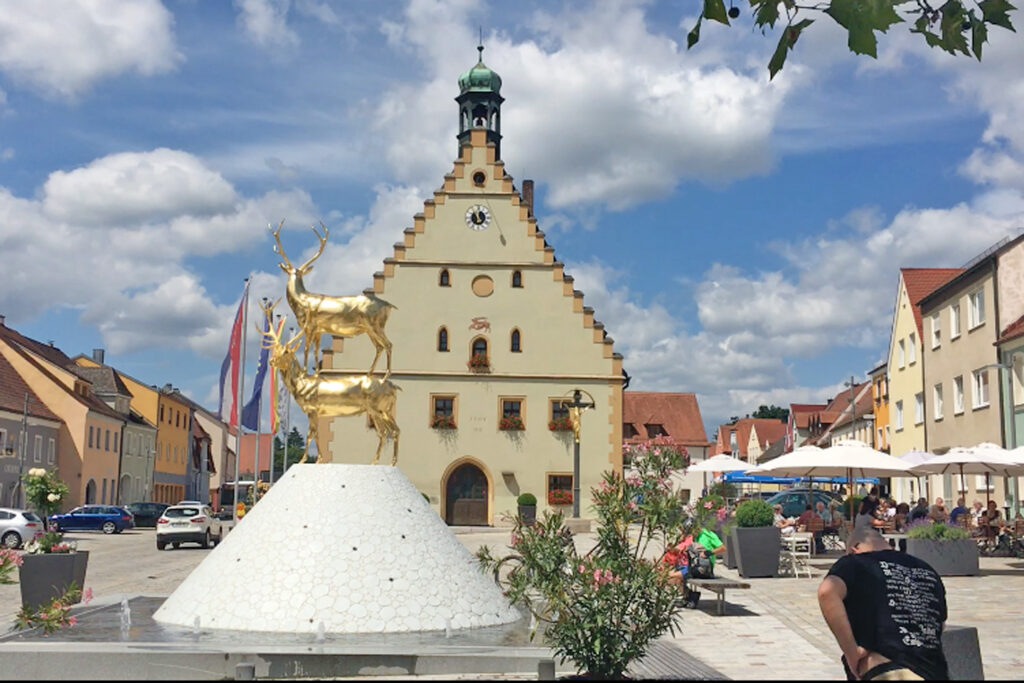 Hirschau town center with Hirsch fountain, pastry shop with street café